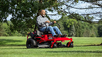 man operating troy-bilt mustang zero-turn mower