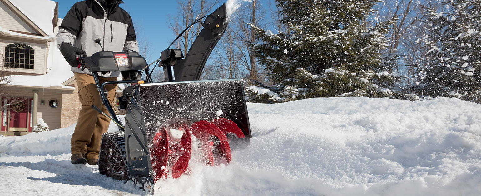 Person snow blowing their driveway