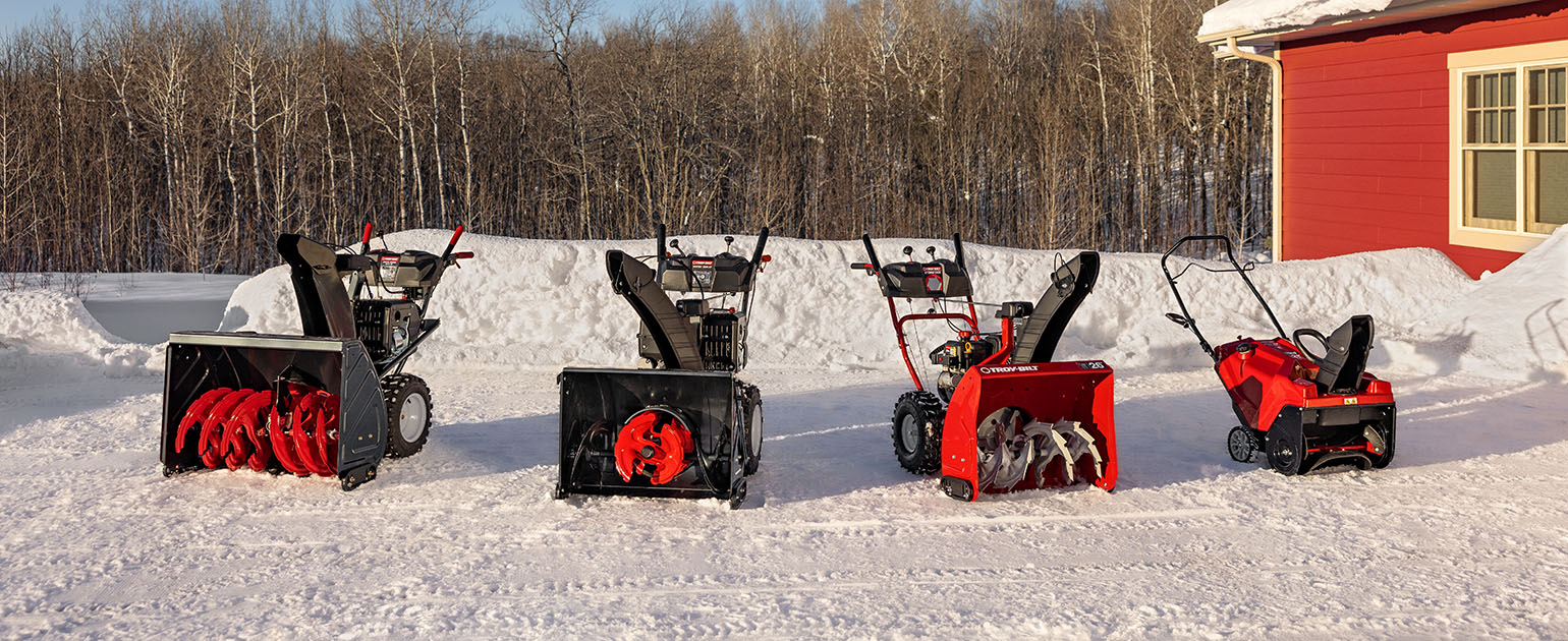 snow blower models lined up outside of building