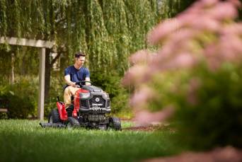 man operating troy-bilt mustang zero-turn mower