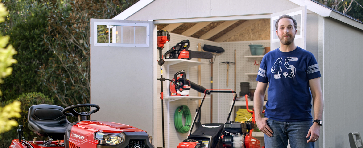 man standing next to his troy bilt power equipment for yard champion campaign