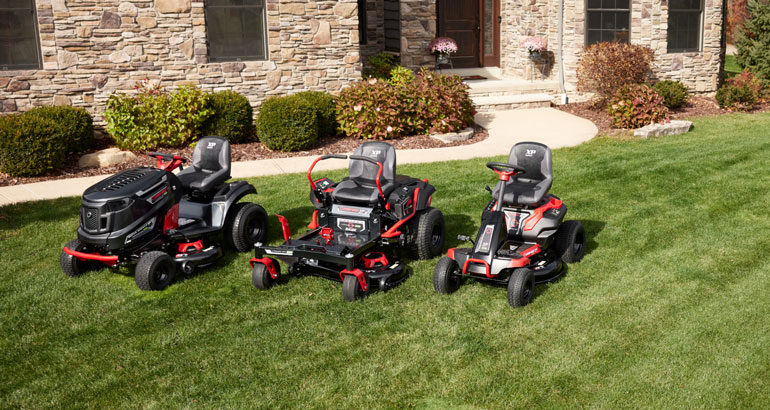 family shot of 3 troy-bilt electric riding mowers
