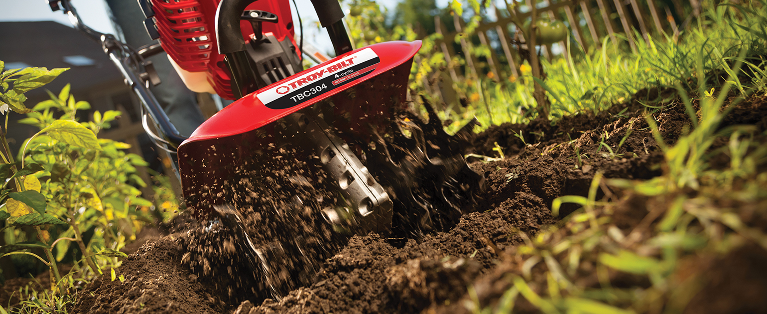 woman using tiller to till soil