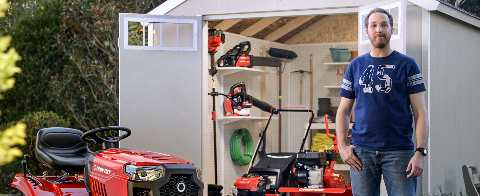 man standing next to his lawn mower