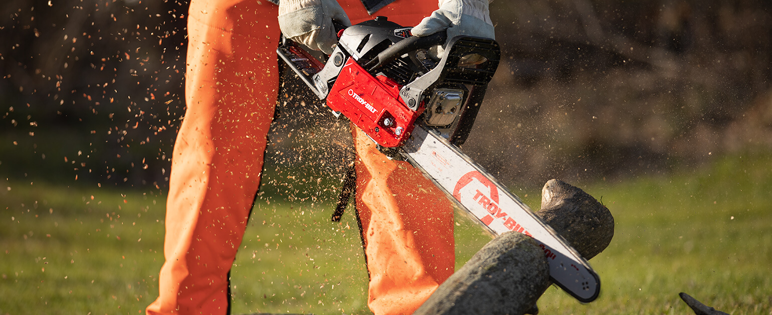 man cutting through a piece of wood