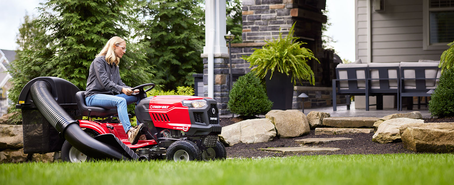 person cutting grass with a troy bilt pony 42 riding lawn mower